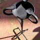 Old ashtray on twisted hammered wrought iron legs, vintage decor.