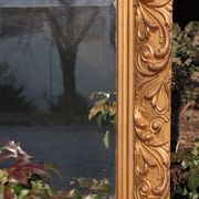 Wooden mirror decorated with gold from the 1920s