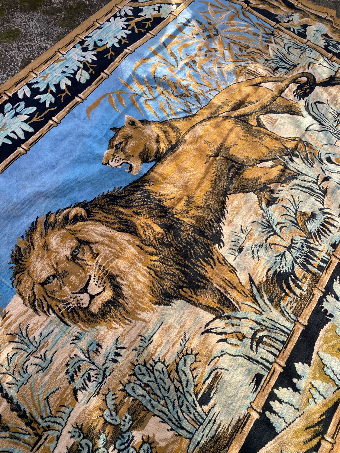 Antique velvet wall tapestry depicting a lion and lioness scene