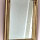 Art Deco mirror in gilded wood with curved floral decorations.