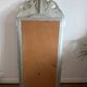 Large antique baroque mirror with angel decorations.