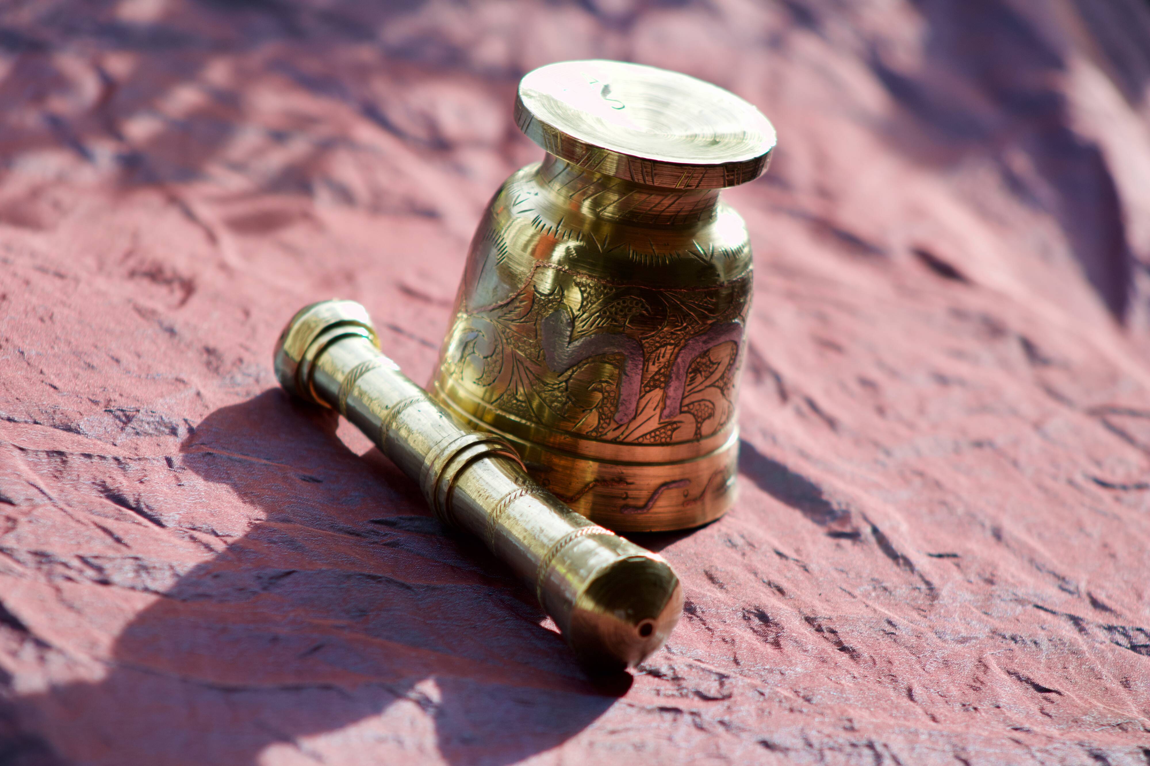 Mortar and its brass pestle with oriental gold and silver motifs