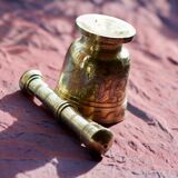 Mortar and its brass pestle with oriental gold and silver motifs