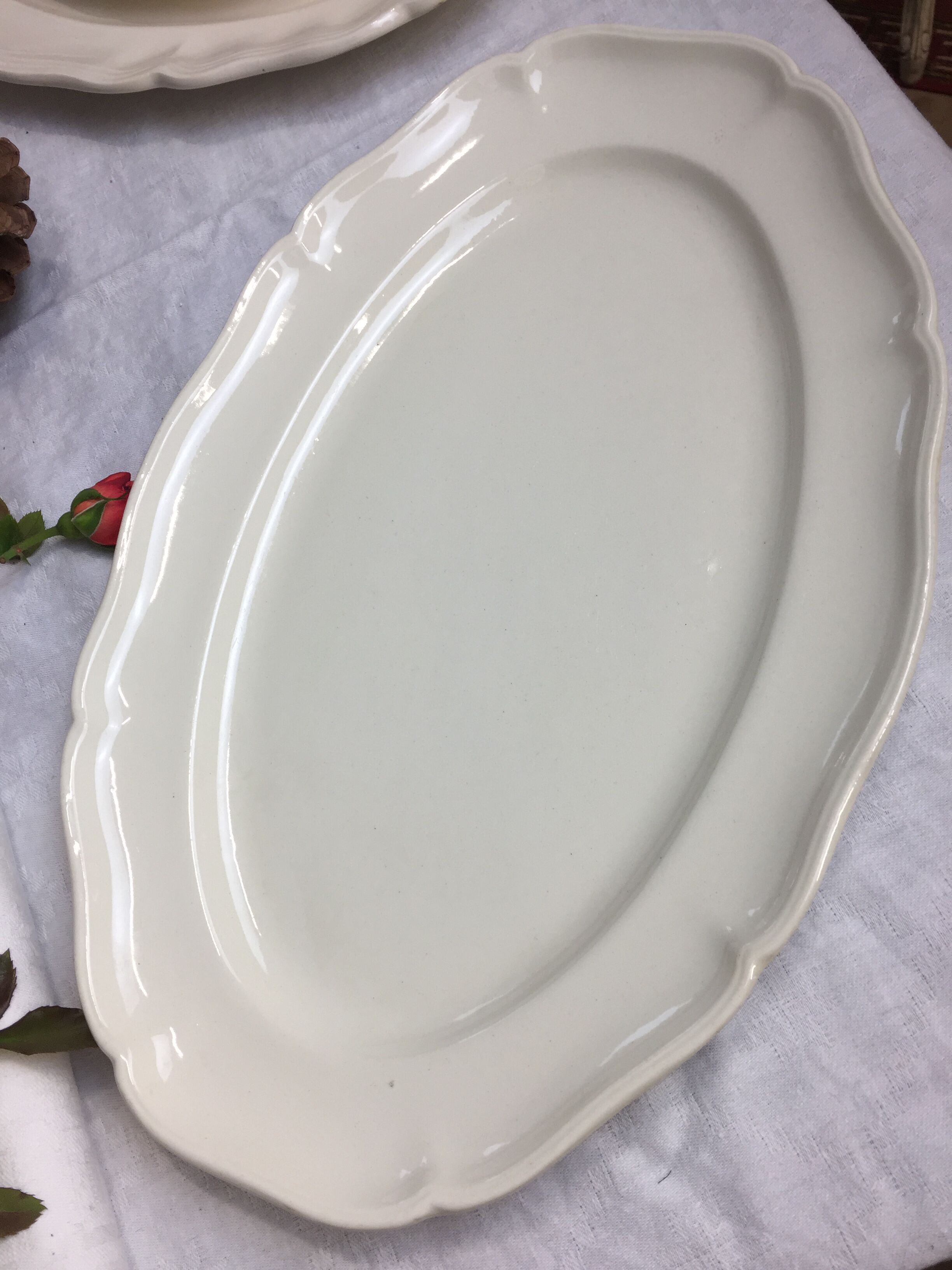 Old ivory-colored, oval-shaped dish with chamfered edge