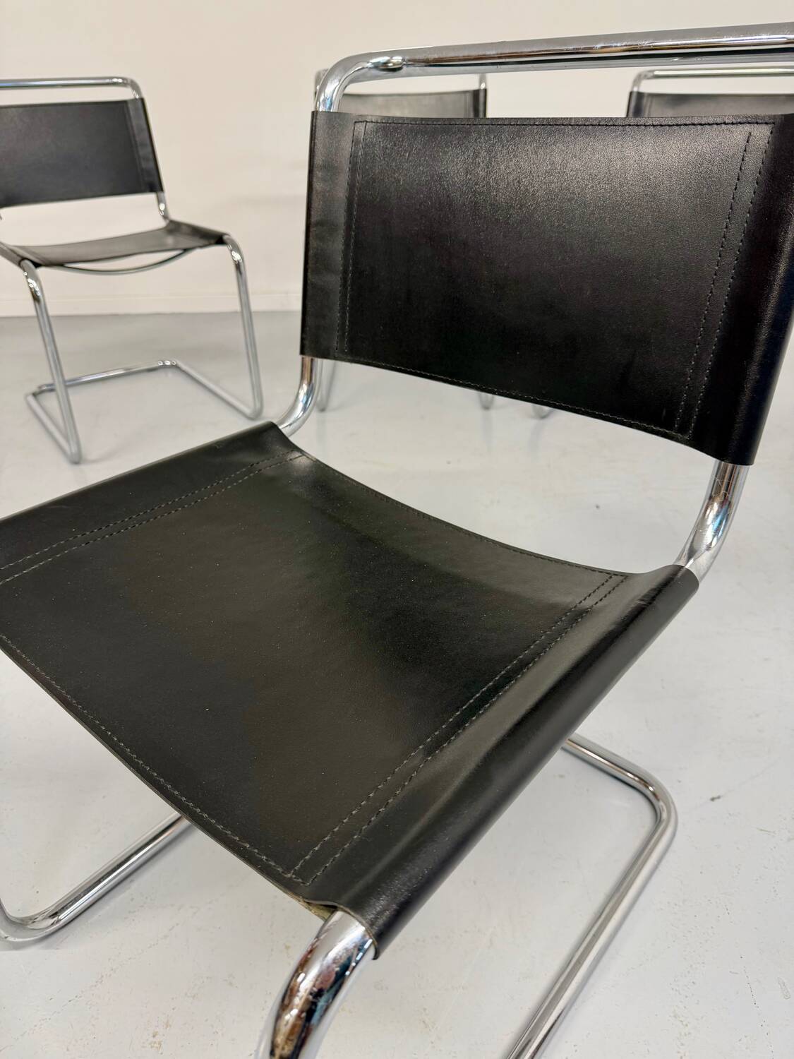 Lot of 4 tubular chairs designed by Mart Stam in vintage black leather from the 1980s.
