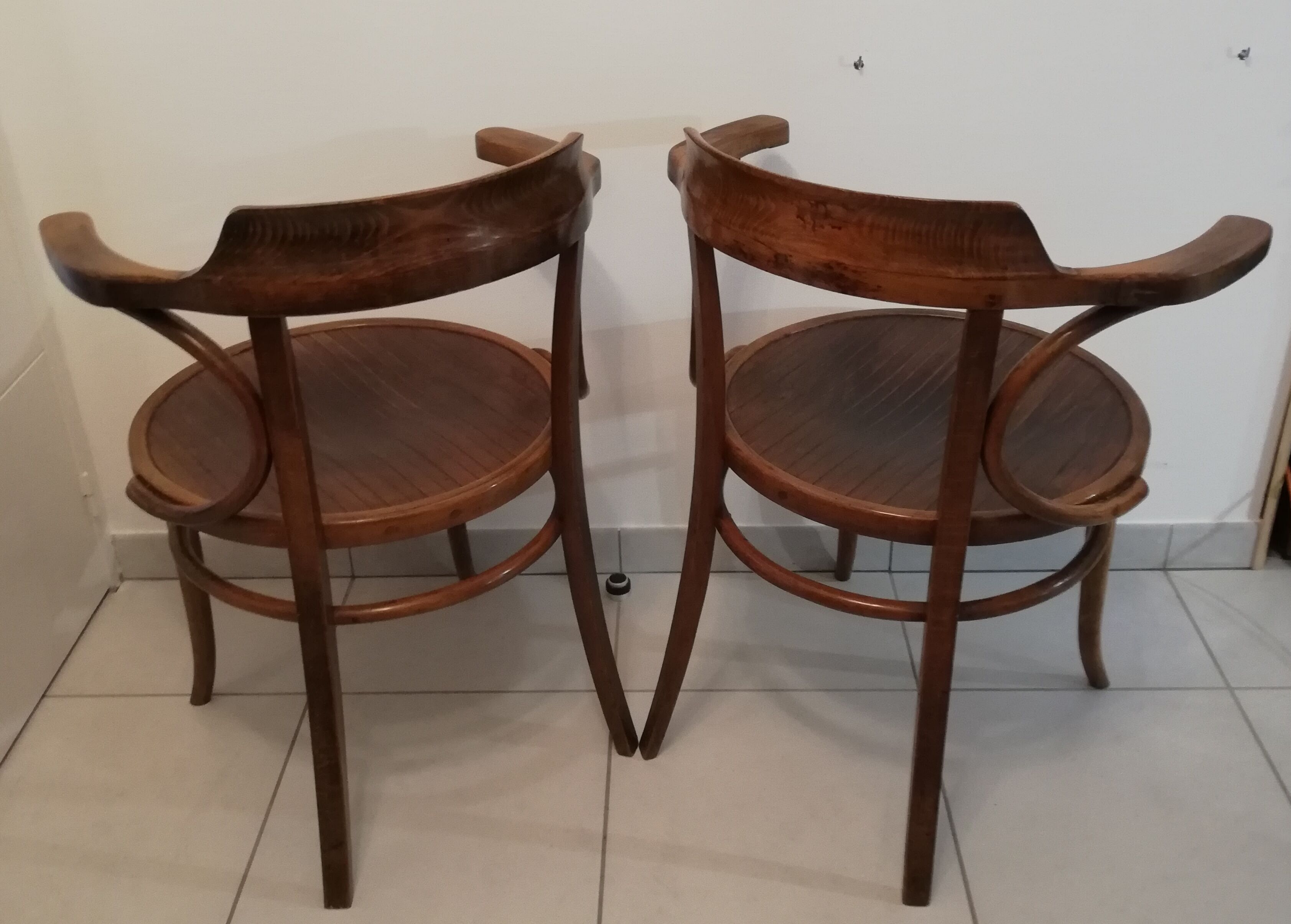 Pair of curved wooden armchairs