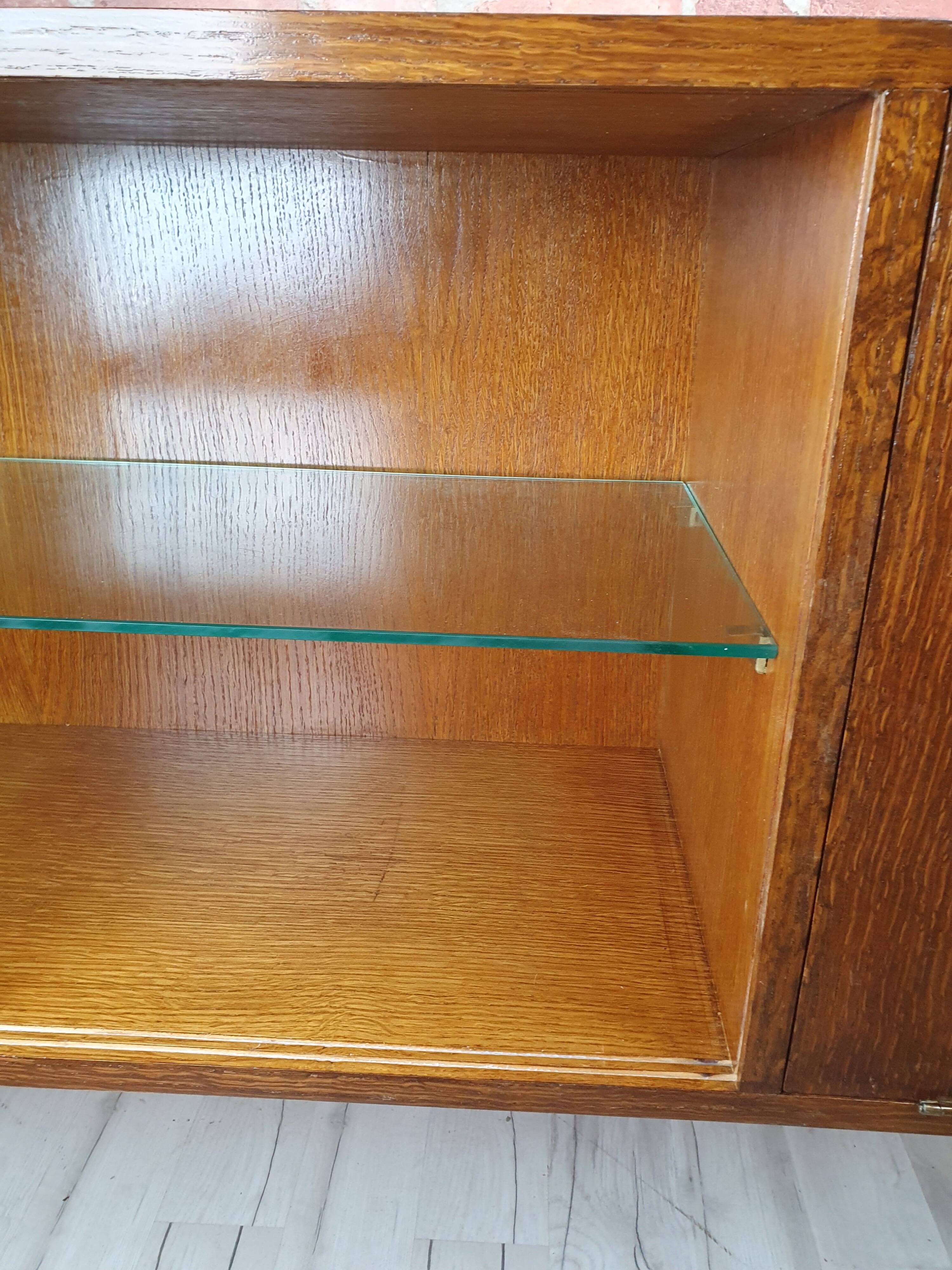 Renovated oak display cabinet with a bar on slanted legs