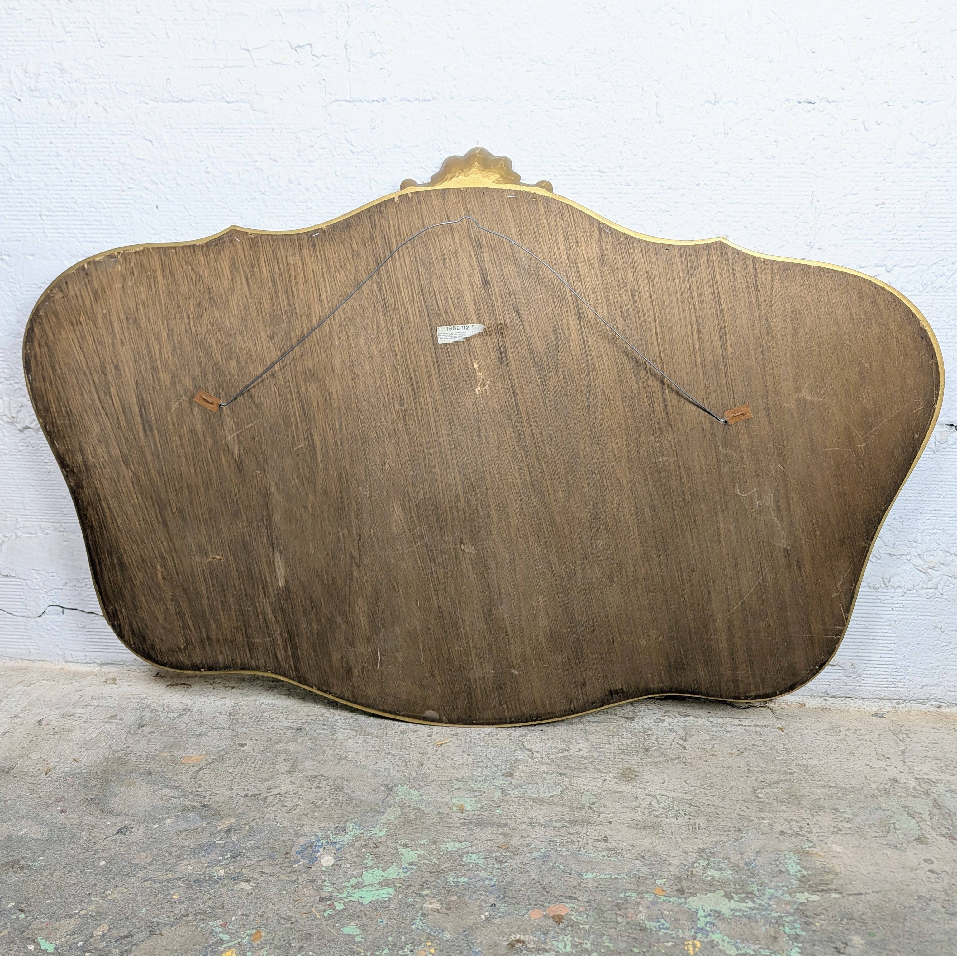 Louis-Philippe gilded mirror with shell pediment