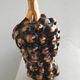 Beautiful black and gold ceramic bottle in the shape of a bunch of grapes.