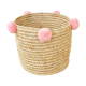 Moroccan basket with pale pink pompoms made of palm fiber