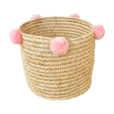 Moroccan basket with pale pink pompoms made of palm fiber