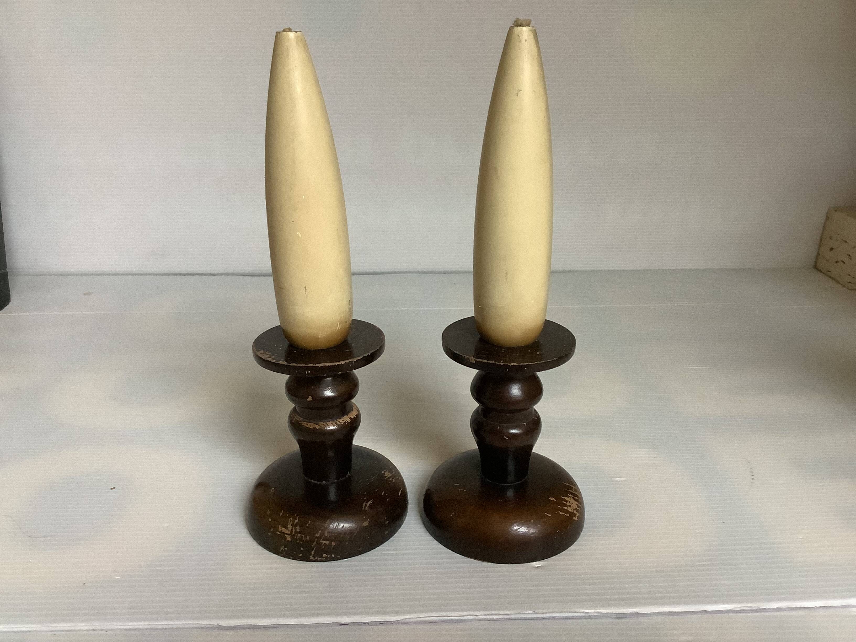 Pair of wooden candlesticks with fake wooden candles.