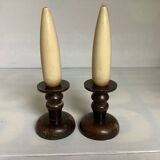 Pair of wooden candlesticks with fake wooden candles.