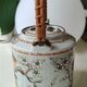 Japanese ceramic teapot. bird/paradise motifs/cherry trees. bamboo/rattan braided handle