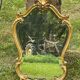 Beveled gilded wood mirror with violin shapes, Louis XV baroque style shell