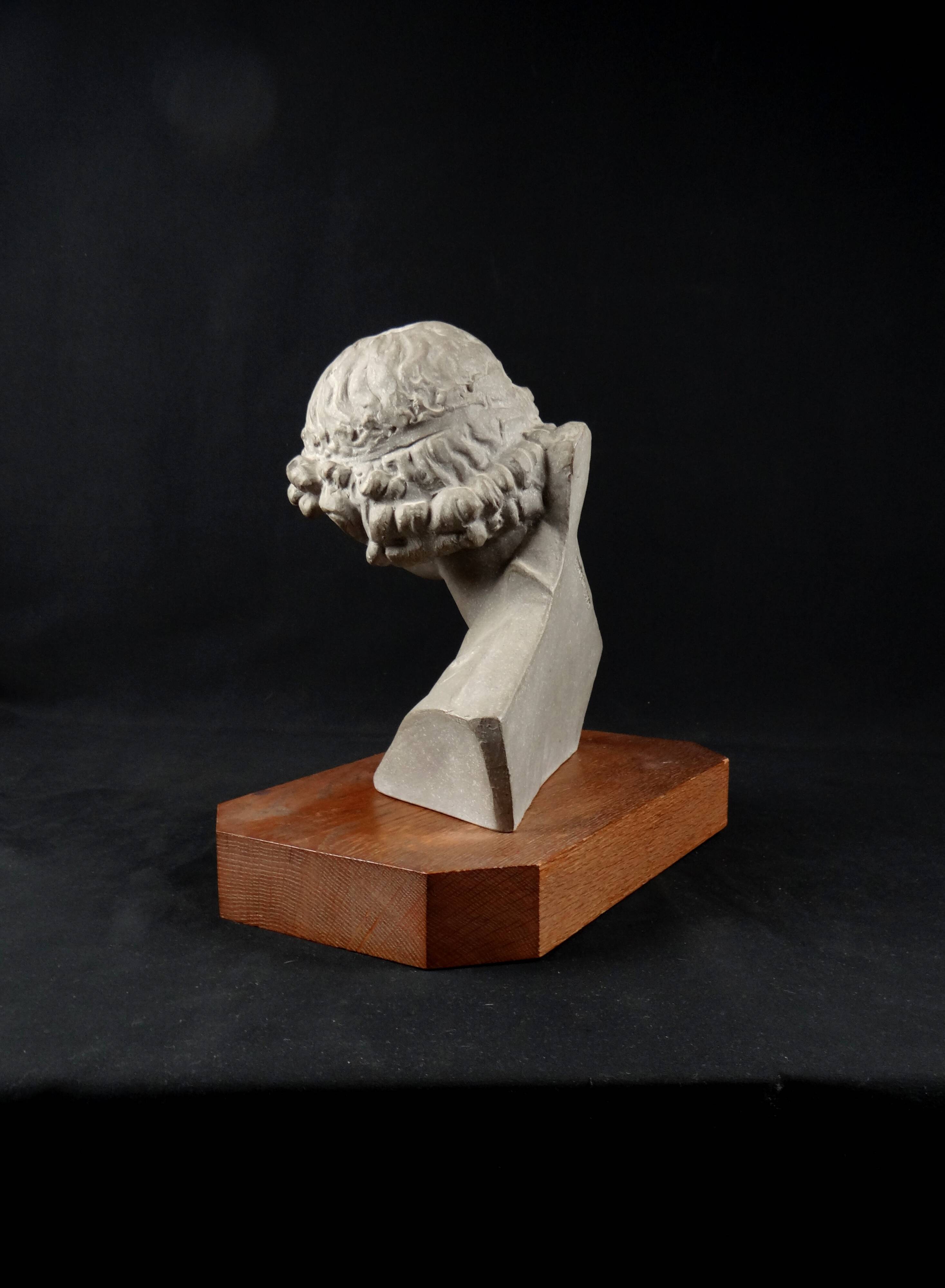 Terracotta bust of the smiling angel from Reims Cathedral with base