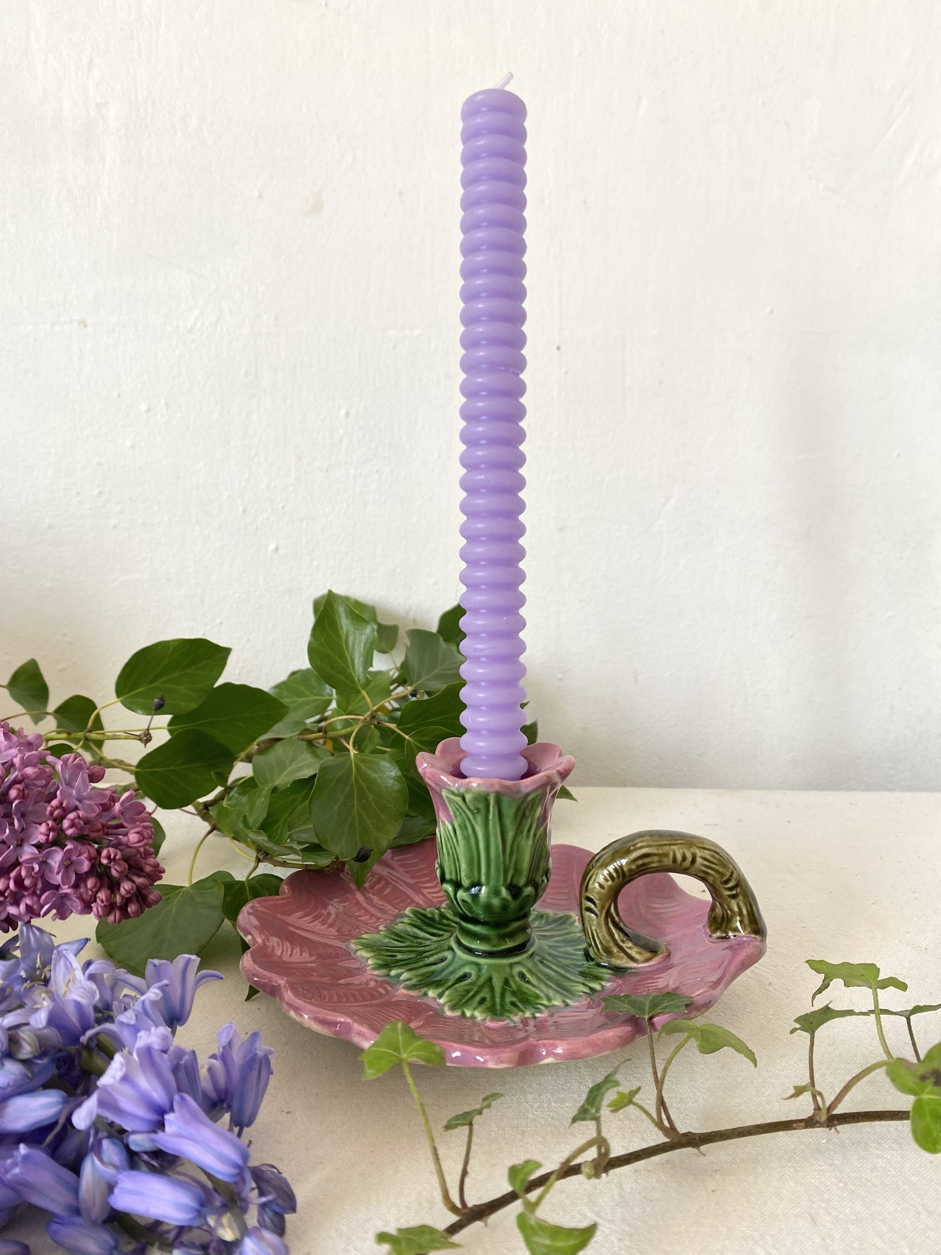 Antique slip candlestick depicting a flower