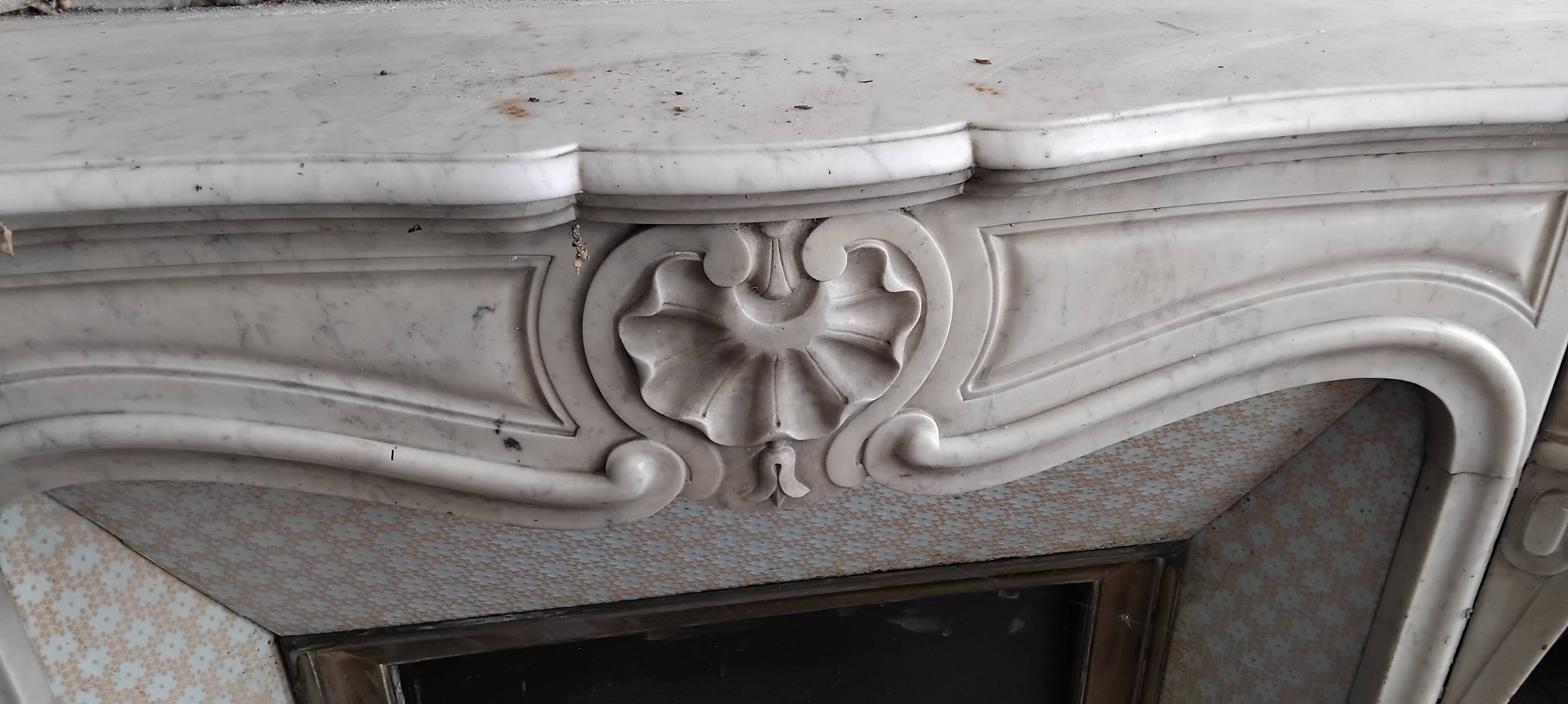 Louis XV style fireplace in veined white Carrara marble and XI ceramics.