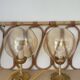2 bedside lamps with round amber glass globes and gold metal.
