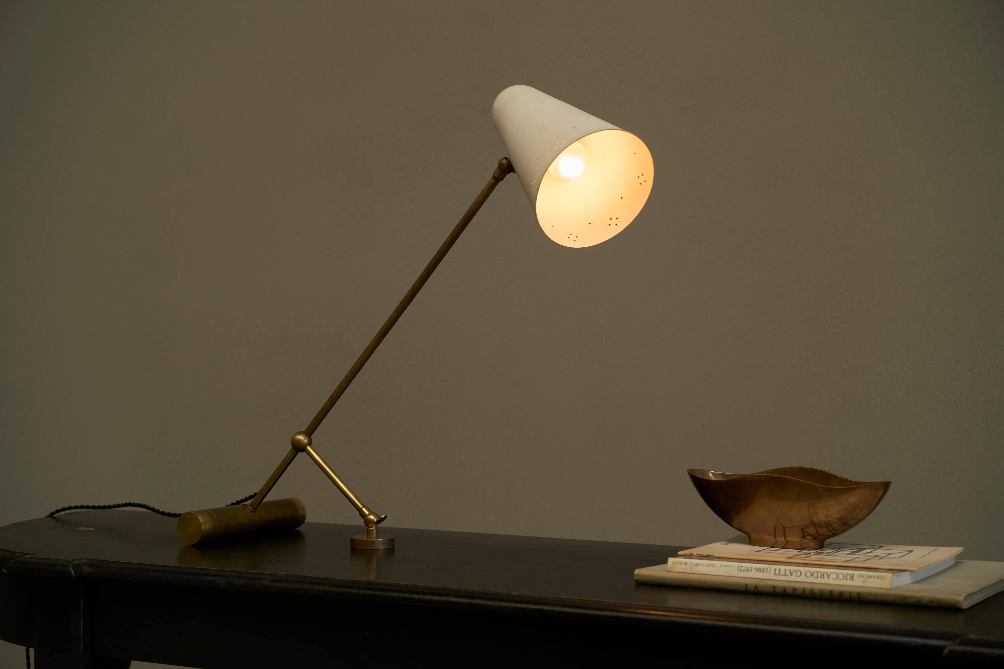 Mid Century adjustable table lamp with perforated shade from the 1950s.