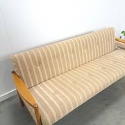 Canapé-lit beige rayé avec cadre en bois