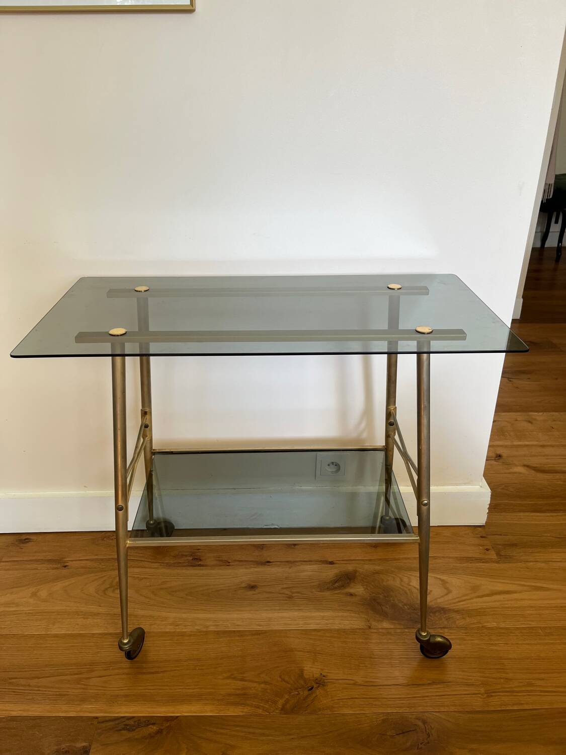 Vintage brass and smoked glass dessert trolley on wheels.