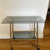 Vintage brass and smoked glass dessert trolley on wheels.