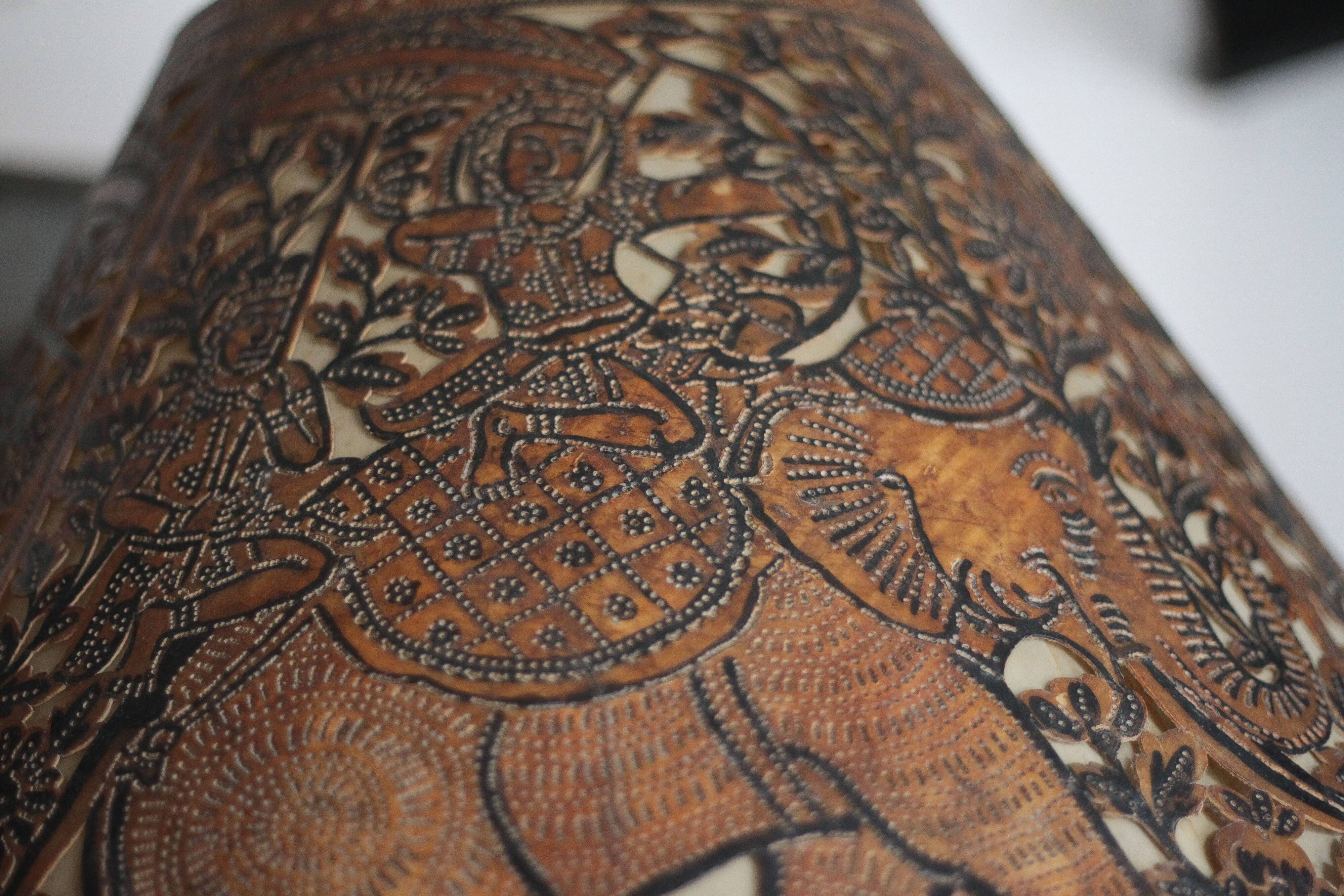 Liane and metal floor lamp with perforated leather shade featuring elephant patterns, lise.