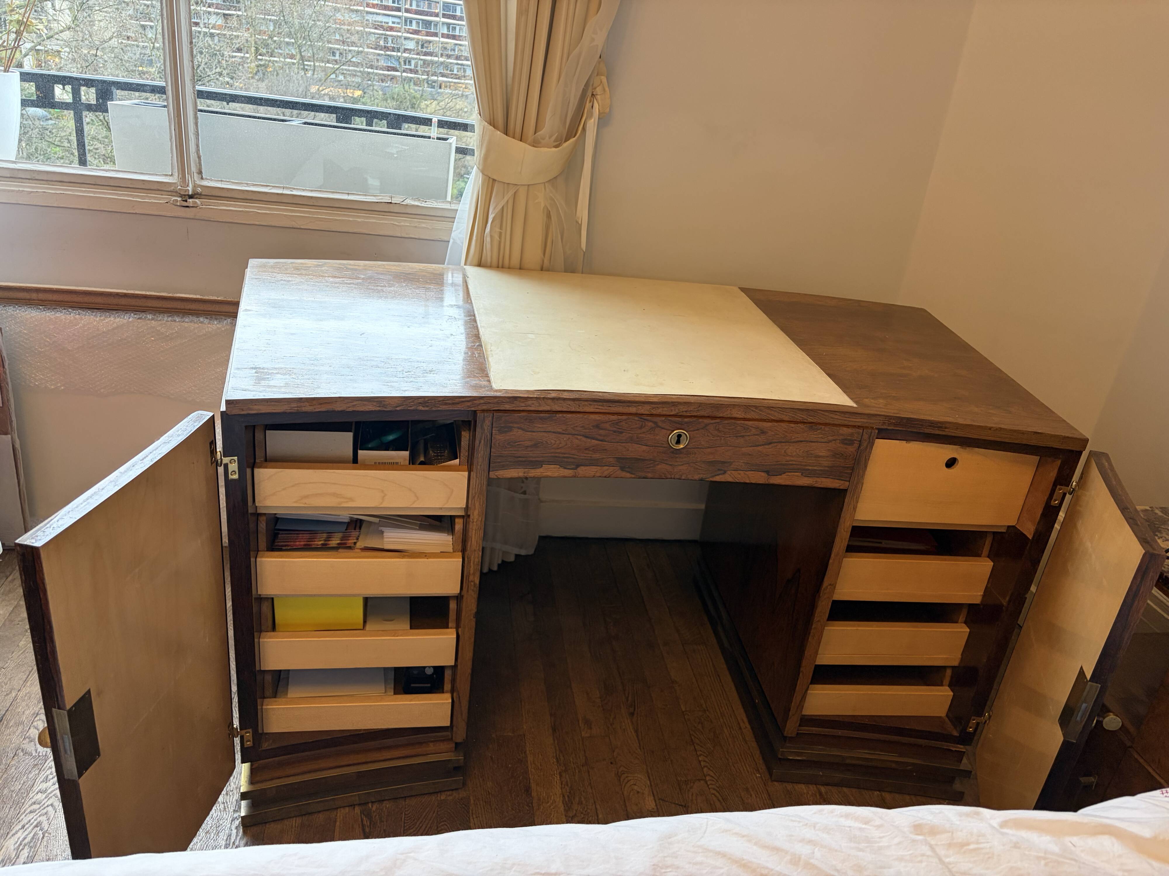 Art Deco desk in a boomerang shape with English-style drawers.