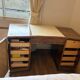 Art Deco desk in a boomerang shape with English-style drawers.