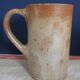 Suite of five sandstone mugs