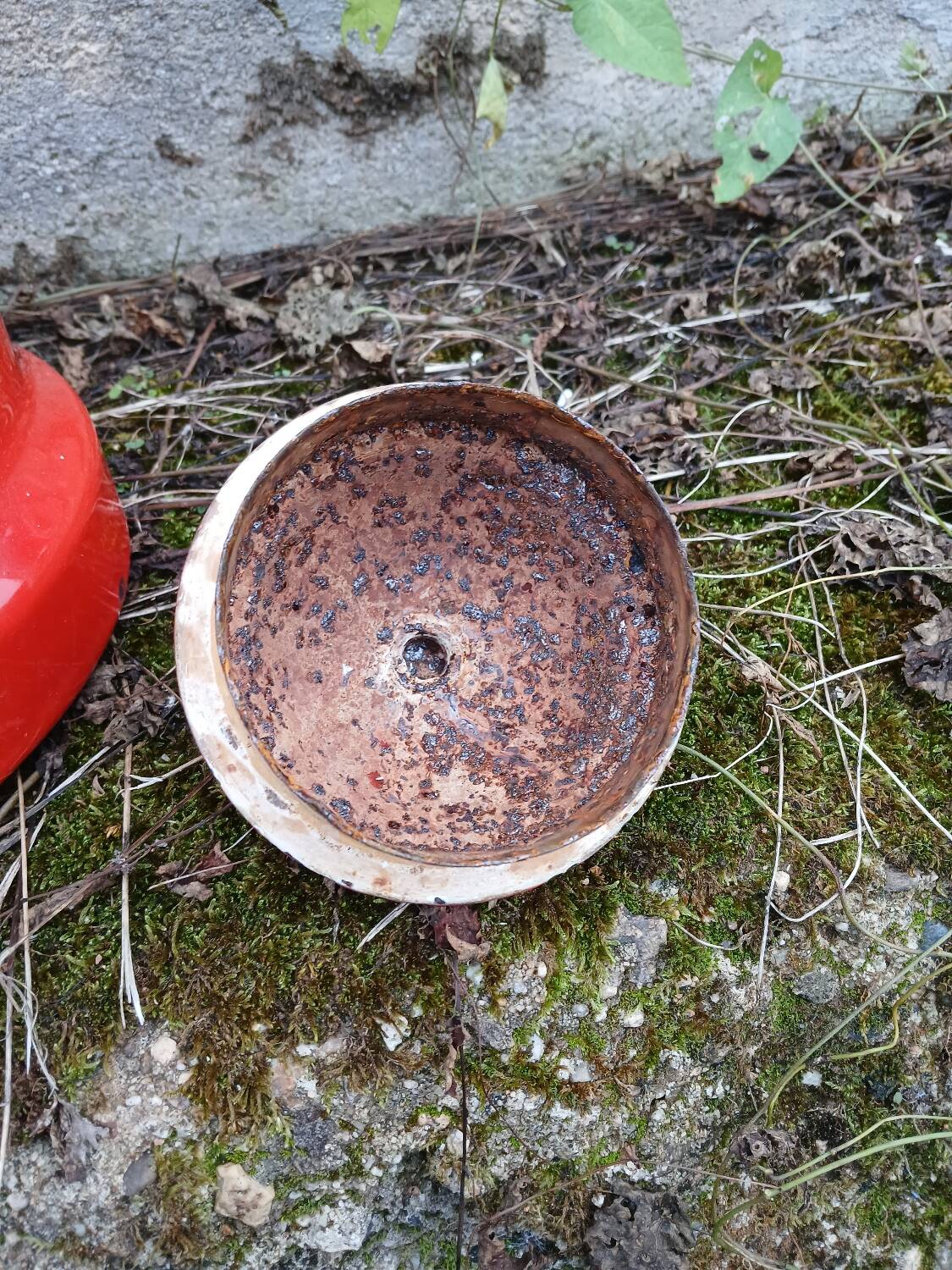 Antique teapot in red enamelled sheet metal
