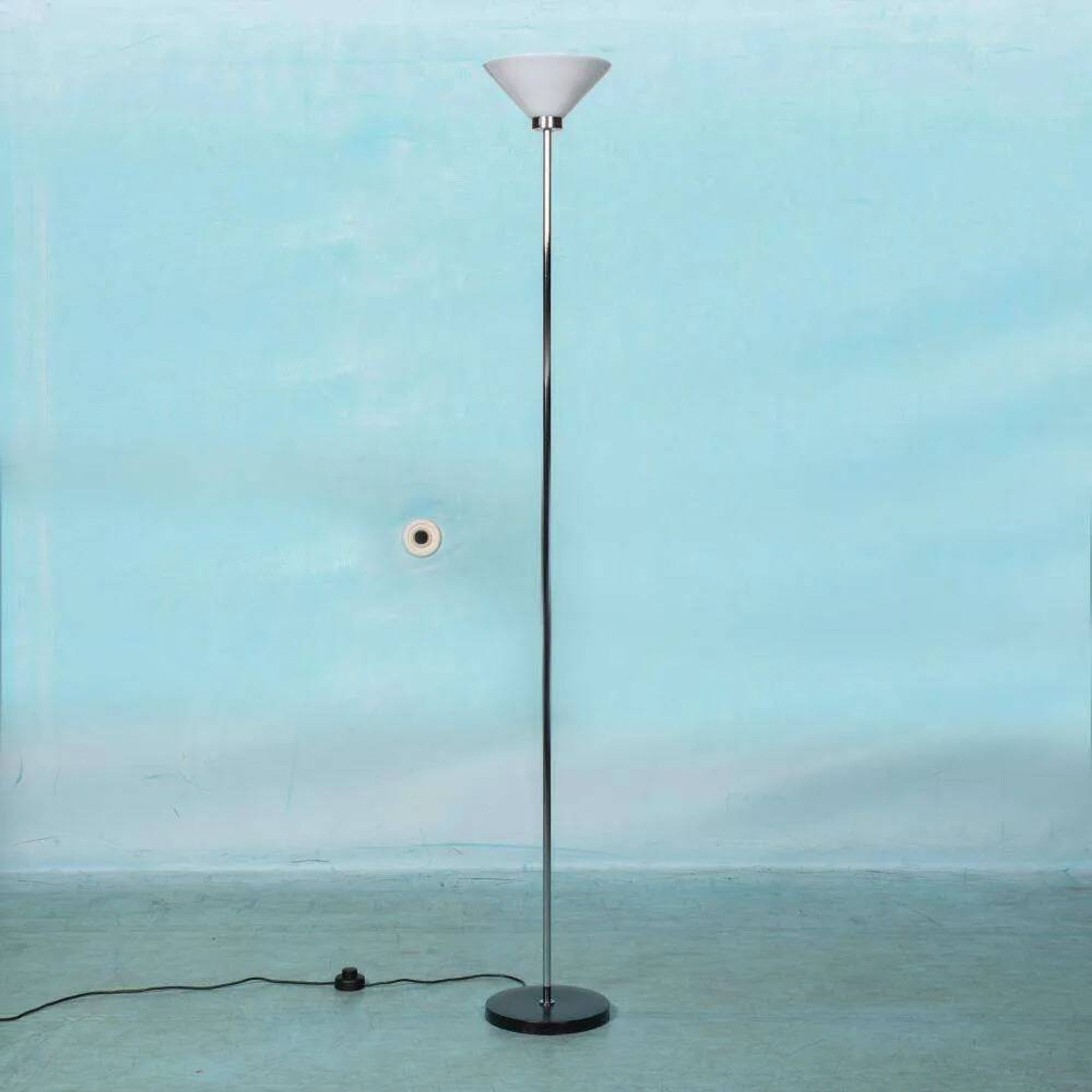 Vintage floor lamp in milky glass and chrome, minimalist uplight lighting.