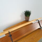 Vintage wall coat rack with black hooks and light wood