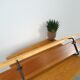 Vintage wall coat rack with black hooks and light wood