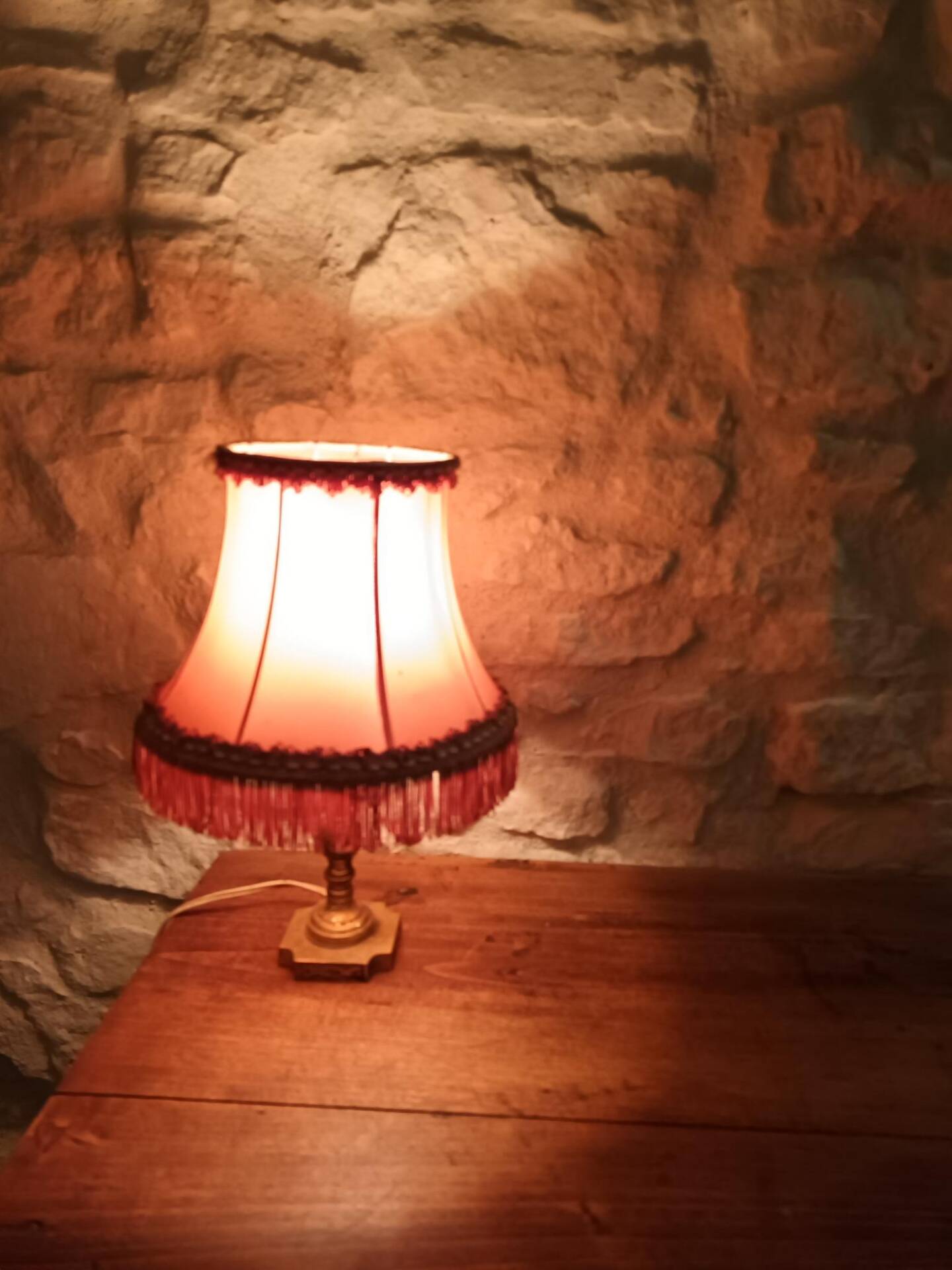 Vintage lamp, pink fringed pagoda shade and brass base.
