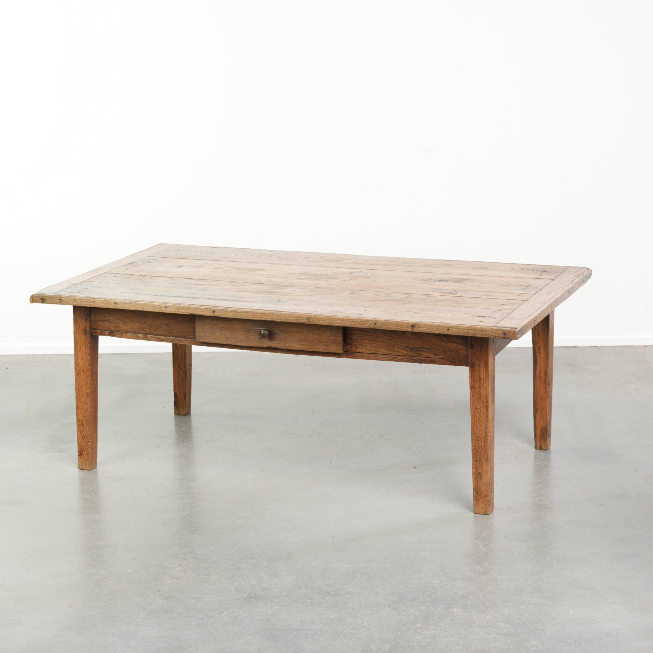 Antique pinewood coffee table with a drawer and a rural appearance