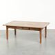 Antique pinewood coffee table with a drawer and a rural appearance