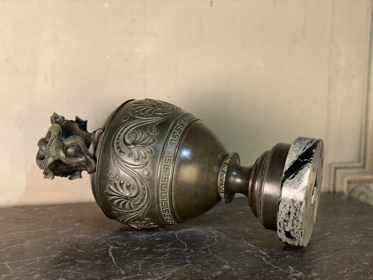 Bronze vase with snakes and a green patina, in the antique style.
