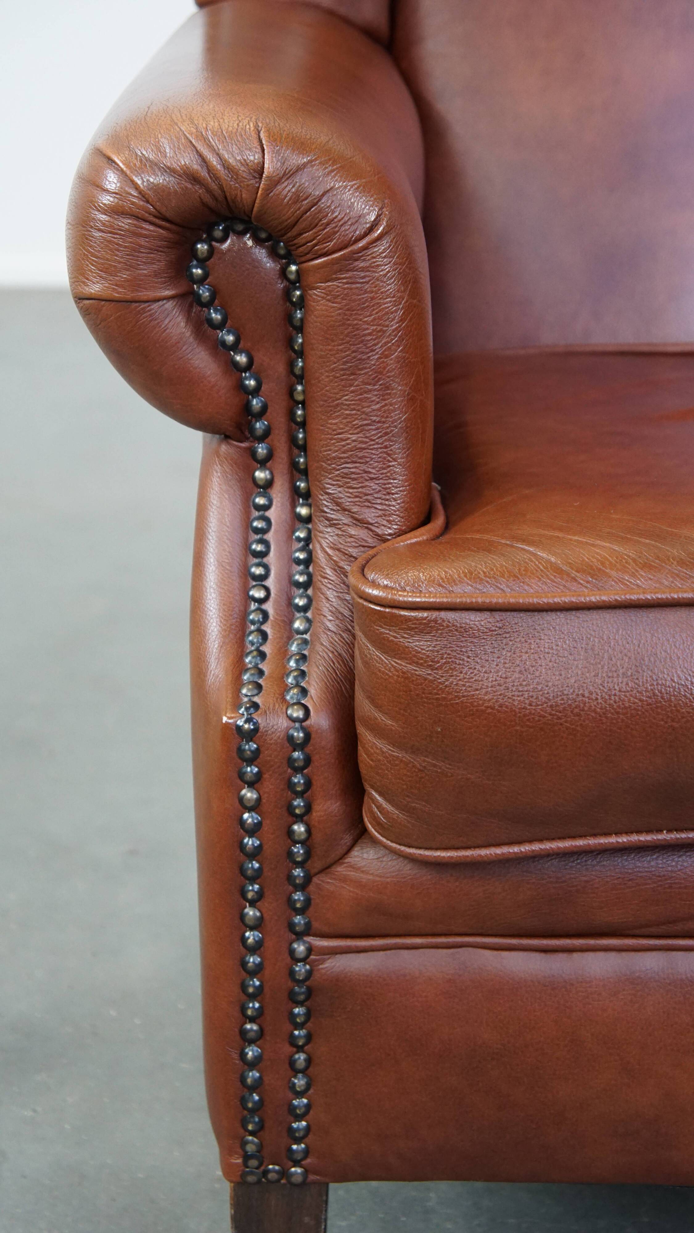 Cognac-colored cowhide wingback chair
