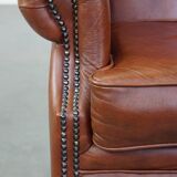 Cognac-colored cowhide wingback chair