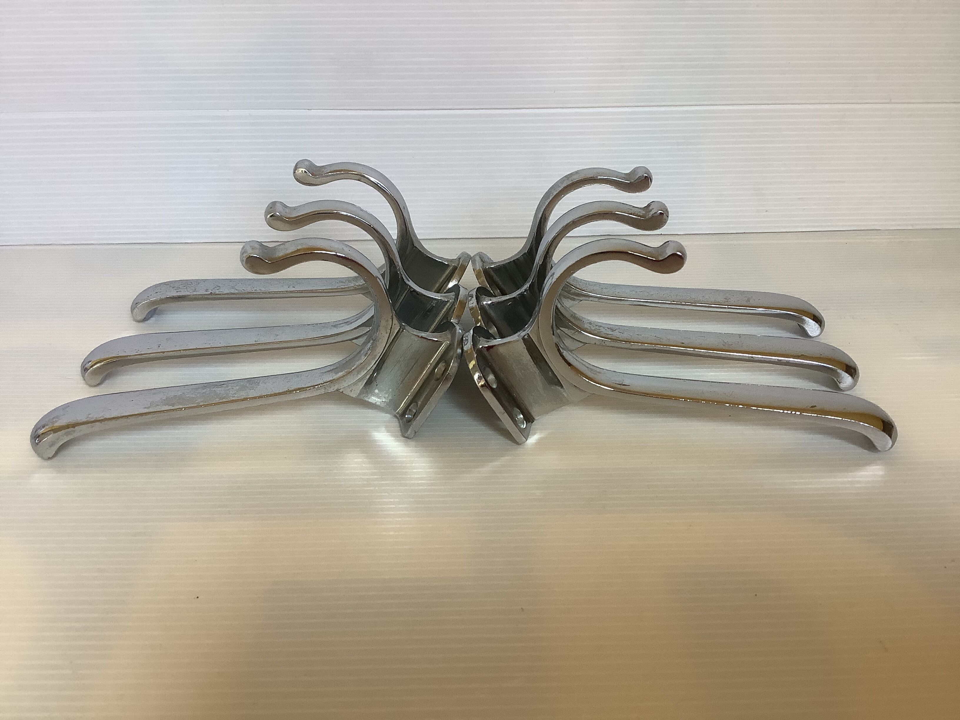 Six old chrome-plated metal hooks
