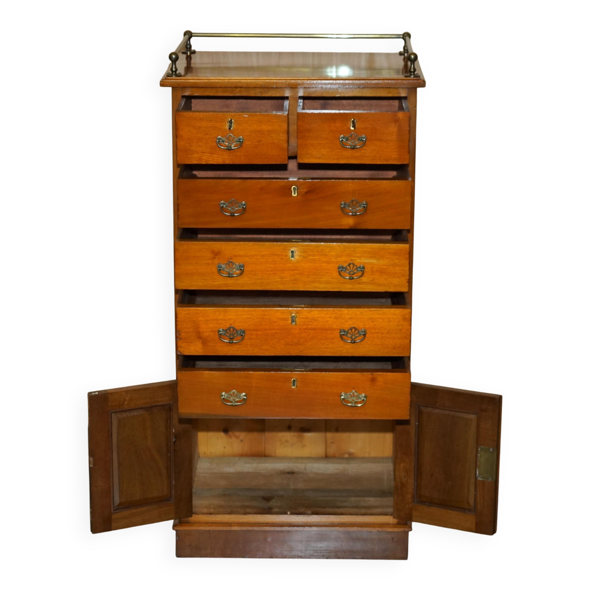 Victorian high chest of drawers in walnut with a bronze gallery.