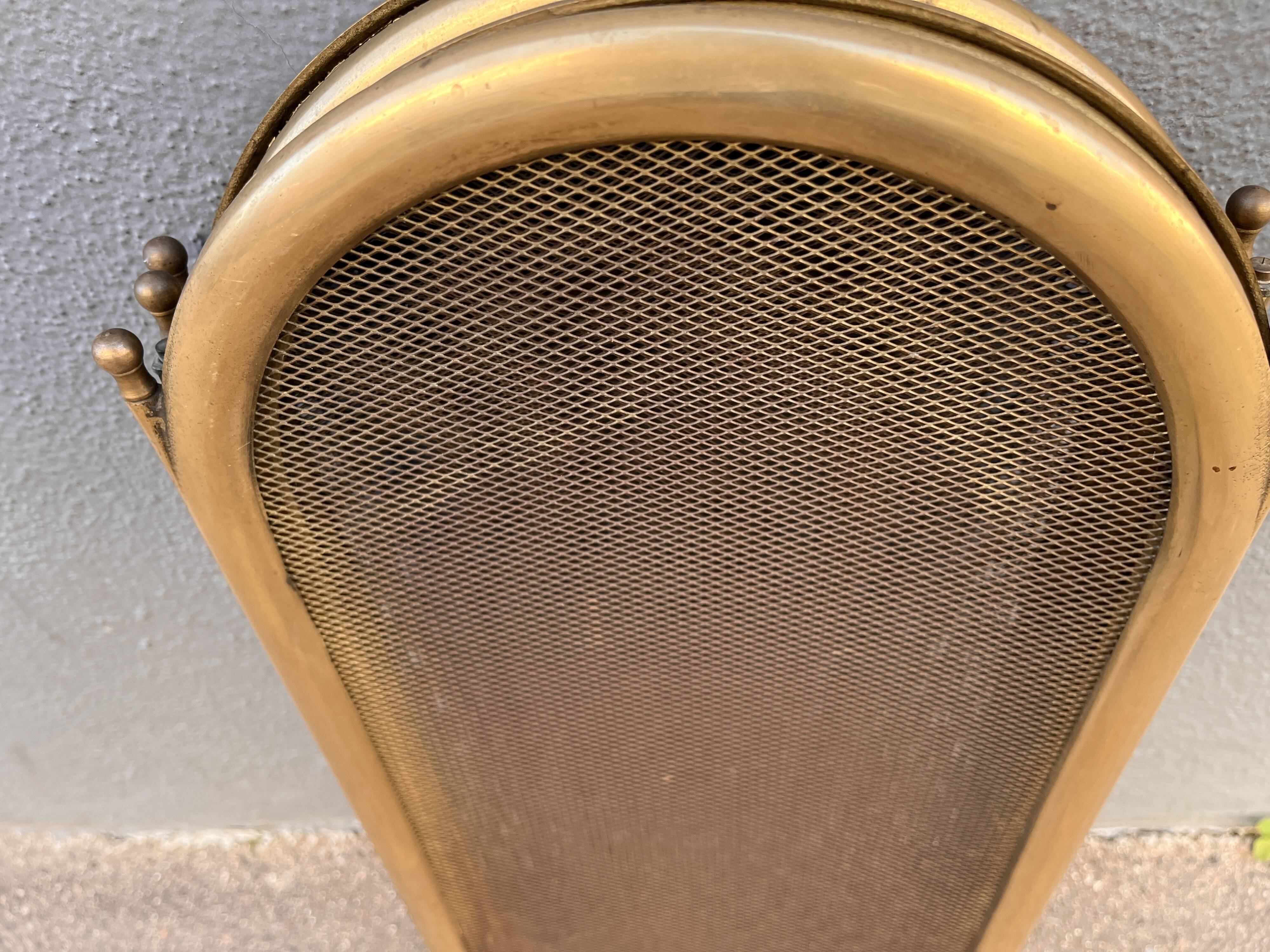 Antique brass fireplace screen from 1920, vintage spark guard.