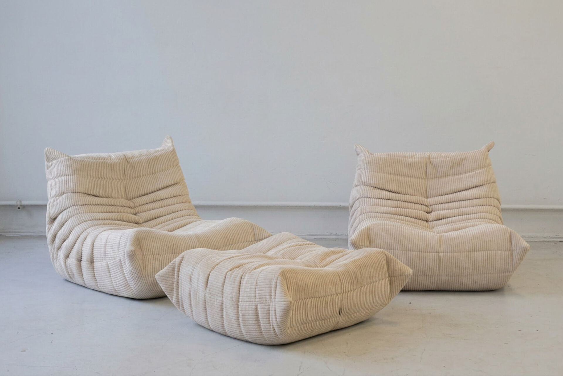Togo set of 2 armchairs and poufne in beige corduroy