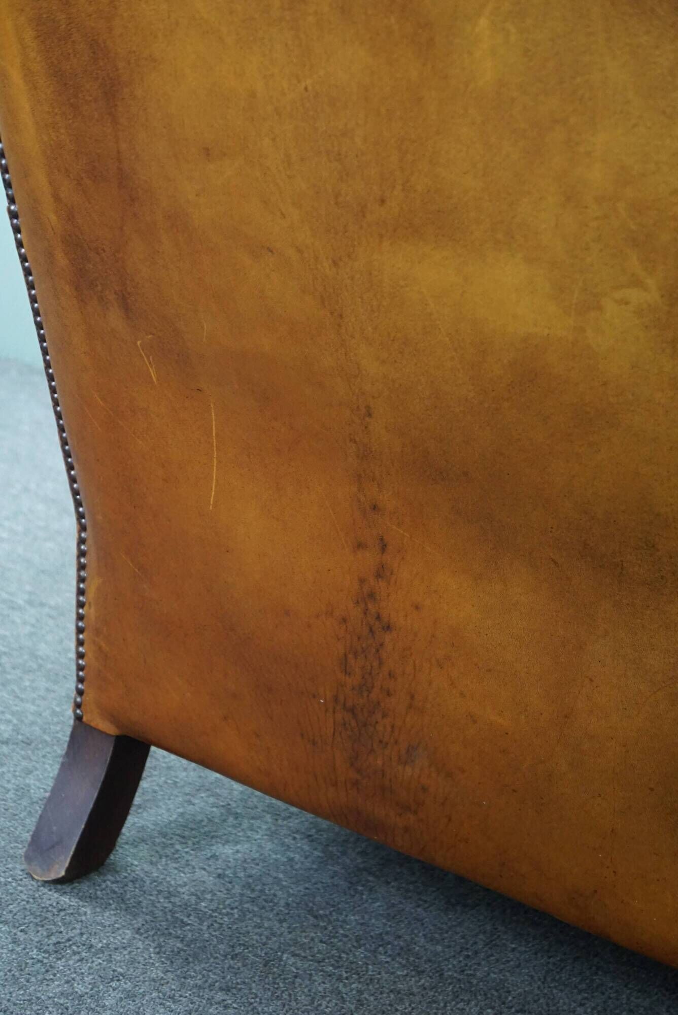 Wingback chair made of sheepskin leather in a light honey color