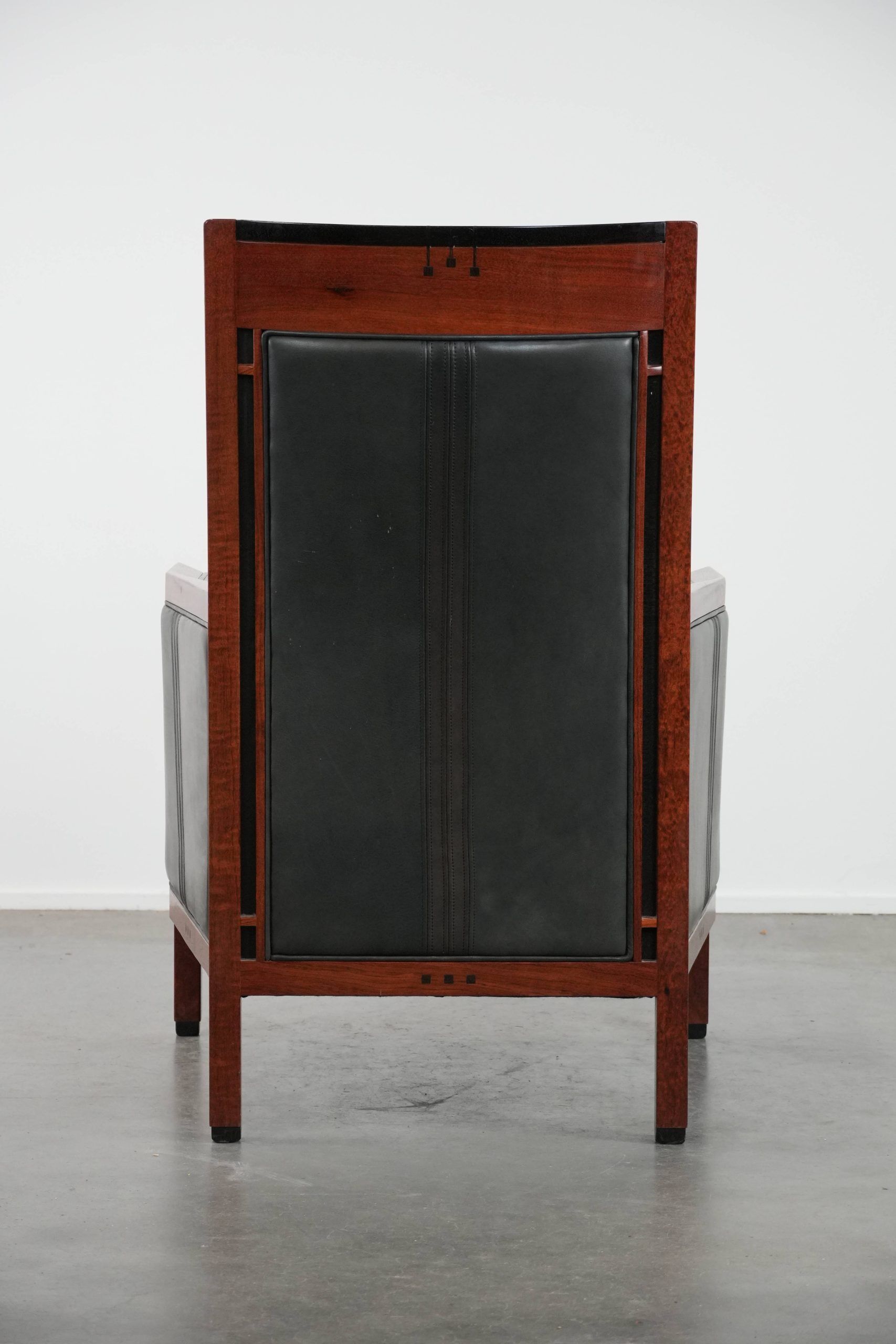 Black Art Deco cowhide leather and wooden design armchair with a high back