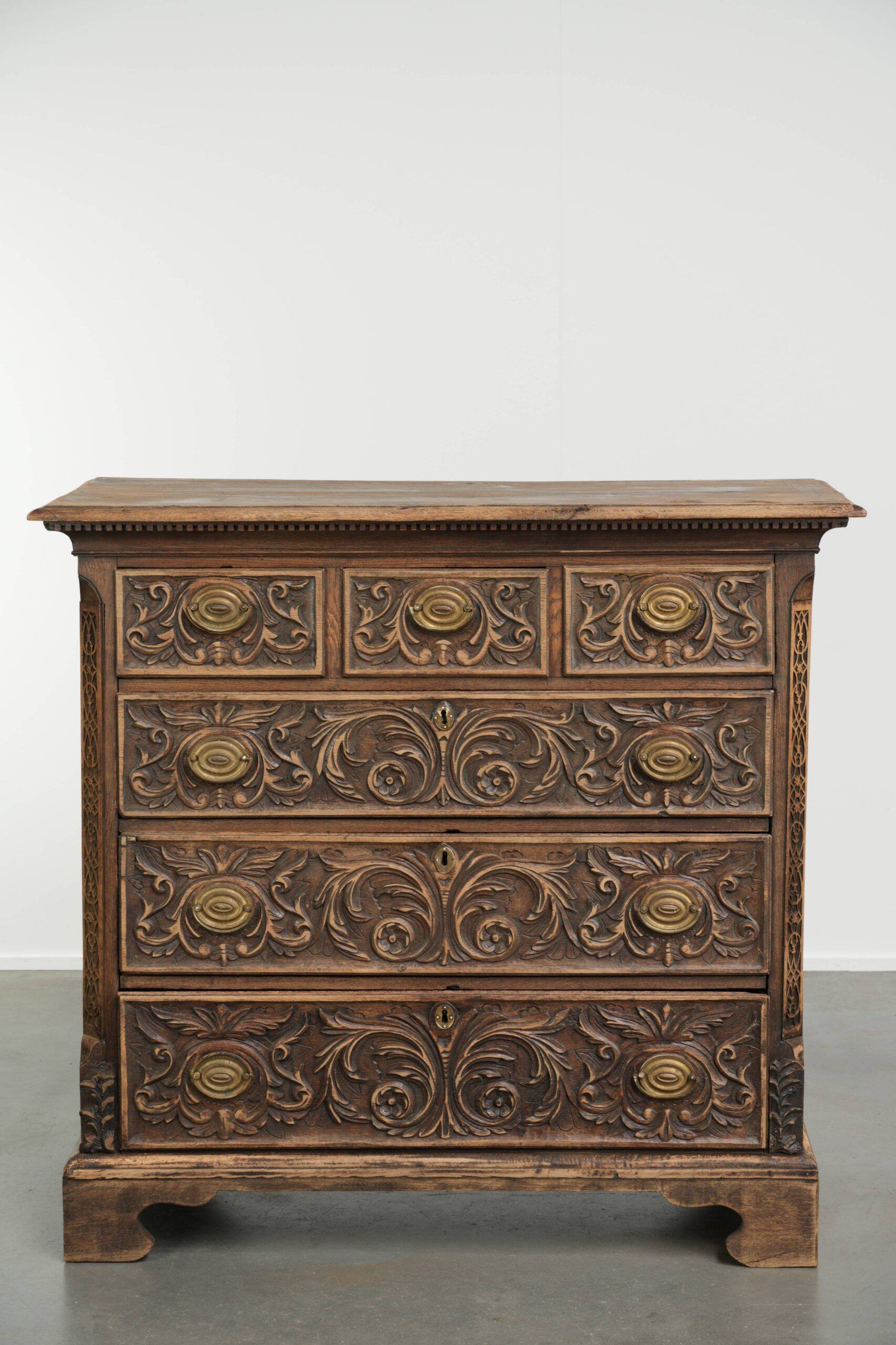 Richly carved English oak chest of drawers from the 18th century