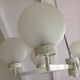 Six-light chrome metal chandelier and opaque glass globes / vintage 60s and 70s