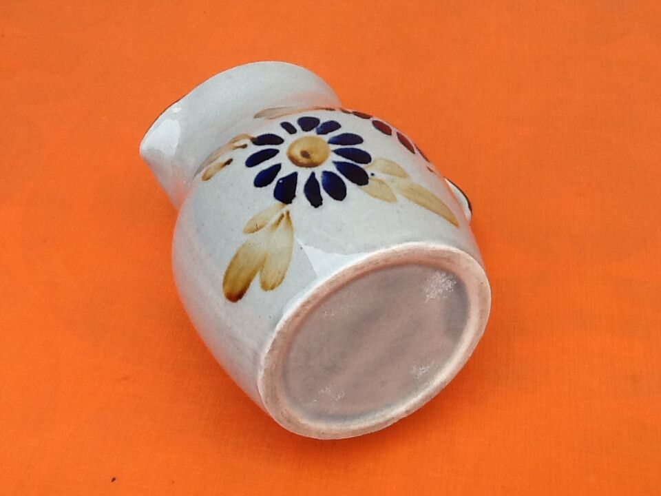 Glazed ceramic pitcher floral decoration